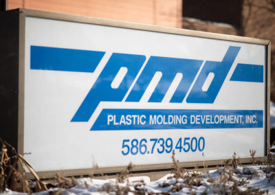 PMD is located on Yearego Drive in Sterling Heights in Macomb County, Michigan. This is a photo of the marquee outside of the building on a snow-filled ground.