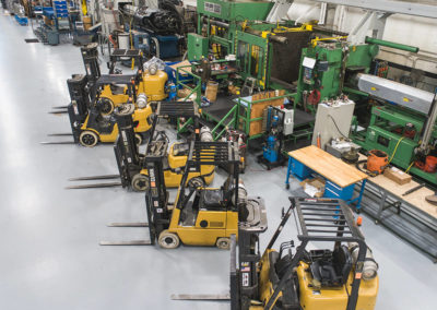 Automotive clients come from around the world to use the machines and equipment. A row of forklifts is shown here.