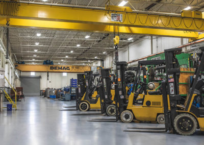 Several forklifts line the floor at Plastic Molding Development Company in Sterling Heights, Michigan.