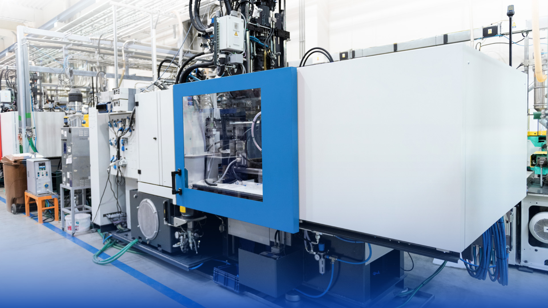 Robotic equipment operating an injection molding machine in a modern manufacturing facility