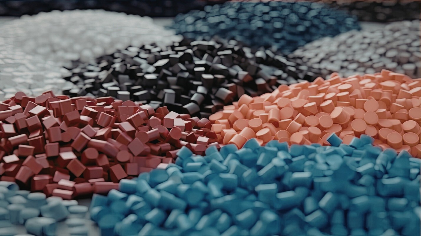 multiple piles of small plastic pellets in various colors, including blue, pink, black, and white. The pellets are cylindrical and rounded shapes, arranged in clusters that highlight color variety and texture differences.